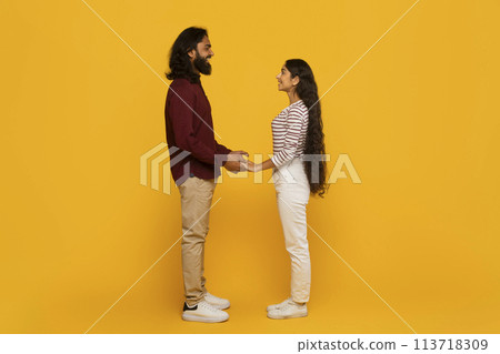 Couple holding hands facing each other Couple holding hands facing each other 113718309
