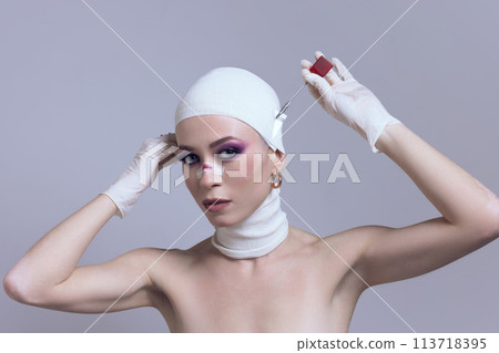Woman with striking makeup unveiling bandage from face after plastic surgery on pastel purple background. Futuristic skincare line Woman with striking makeup unveiling bandage from face after plastic surgery on pastel purple background. Futuristic skincare line 113718395
