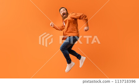 Overjoyed bearded man jumping in mid air and shouting, studio Overjoyed bearded man jumping in mid air and shouting, studio 113718396