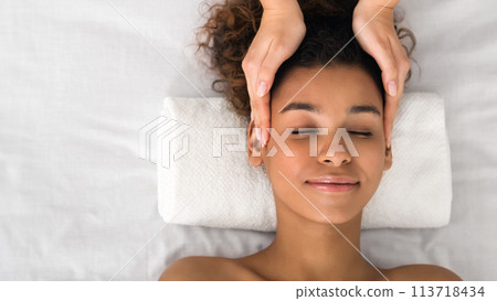 Lady in a serene spa head massage moment Lady in a serene spa head massage moment 113718434