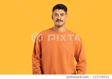 Man with moustache standing against yellow background 113718552