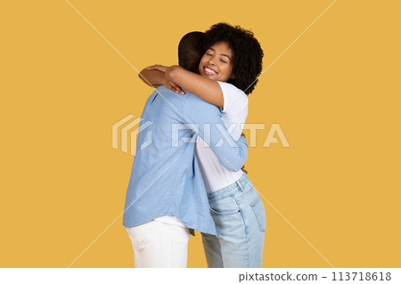 Couple hugging each other gently on yellow 113718618