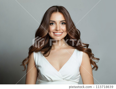 Perfect young woman with long wavy hairstyle, makeup and perfect smile, fashion portrait.  113718639