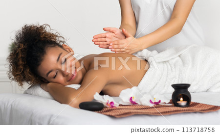Woman receiving back massage in spa salon 113718758