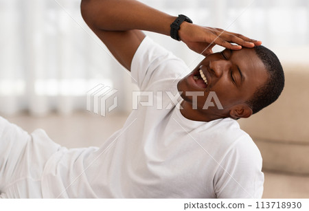 Man doing abdominal workout in living room 113718930