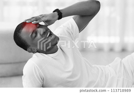 Man stretching back muscles at home grayscale 113718989