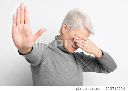 Elderly woman with hand up in refusal 113719234