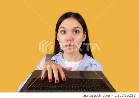 Surprised Student Looking Over Laptop Screen, closeup 113719238