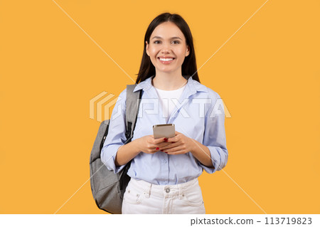 Young Woman with Phone Looking Pleasantly Surprised Young Woman with Phone Looking Pleasantly Surprised 113719823