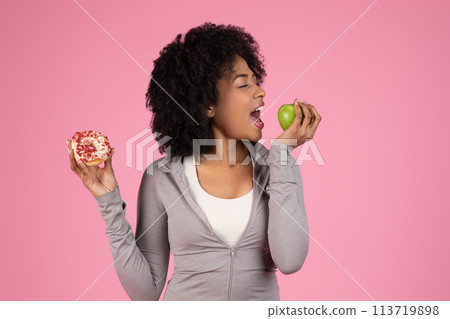 Lady choosing between donut and apple on pink background Lady choosing between donut and apple on pink background 113719898