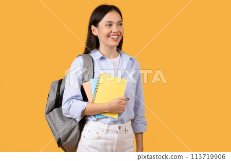 Smiling Girl Holding Notebooks, Looking Away, Copy Space Smiling Girl Holding Notebooks, Looking Away, Copy Space 113719906