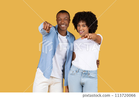 Engaging African American couple pointing directly at camera with confident smiles Engaging African American couple pointing directly at camera with confident smiles 113720066