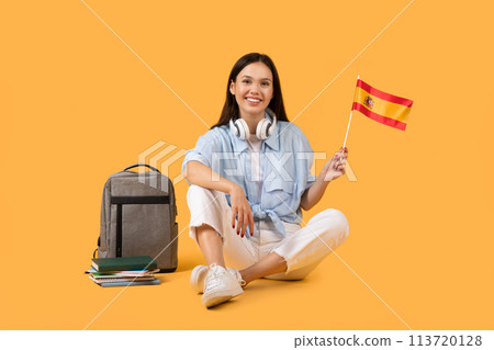 Happy woman with Spanish flag on yellow background Happy woman with Spanish flag on yellow background 113720128