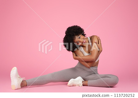 Black woman in a complex yoga pose Black woman in a complex yoga pose 113720252