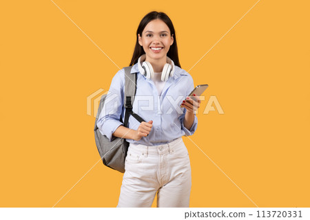Student with Phone and Headphones on Yellow Student with Phone and Headphones on Yellow 113720331