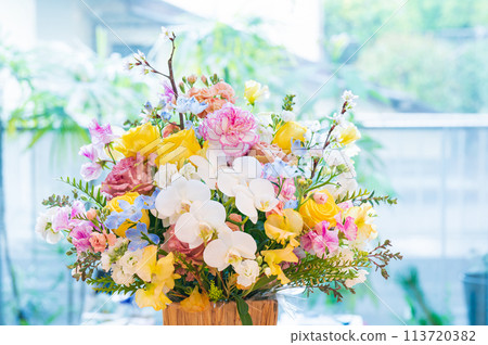 Colorful flower arrangement on the table Colorful flower arrangement on the table 113720382