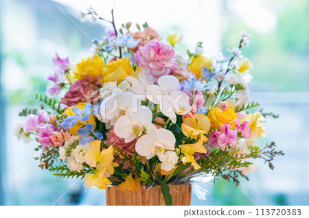Colorful flower arrangement on the table Colorful flower arrangement on the table 113720383