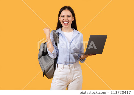 Excited Lady Student Celebrating Success with Laptop Excited Lady Student Celebrating Success with Laptop 113720417