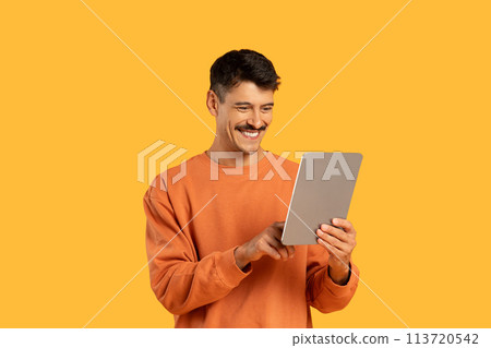 Man with a tablet and happy expression 113720542
