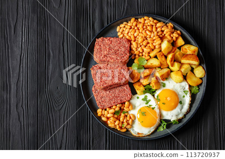 corned beef, baked beans, potatoes and fried eggs 113720937