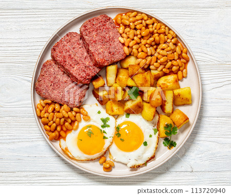 corned beef, baked beans, potatoes and fried eggs corned beef, baked beans, potatoes and fried eggs 113720940