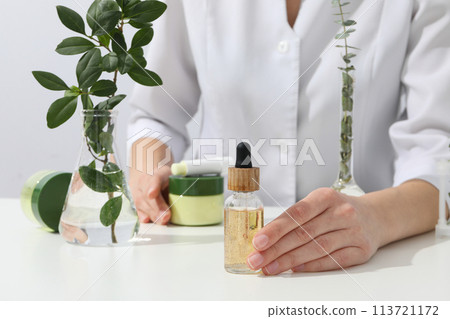 Cosmetics with chemical flasks and a flower Cosmetics with chemical flasks and a flower 113721172