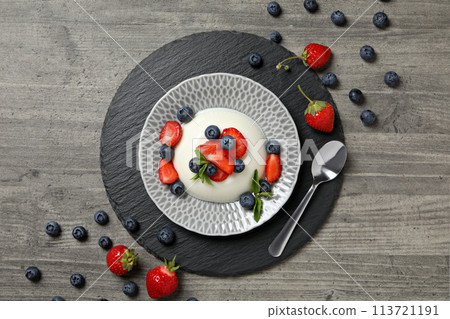 Dessert panna cotta, on the table, on a gray background. 113721191