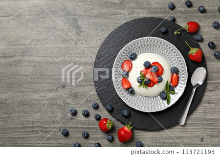 Dessert panna cotta, on the table, on a gray background. 113721193