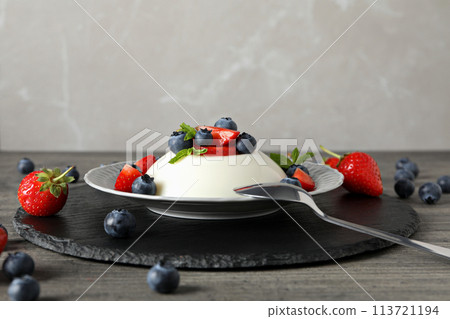 Dessert panna cotta, on the table, on a gray background. Dessert panna cotta, on the table, on a gray background. 113721194