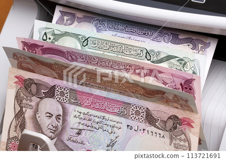 Old Afghan Afghani in a counting machine Old Afghan Afghani in a counting machine 113721691