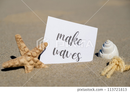 MAKE WAVES text on paper greeting card on background of starfish seashell summer vacation decor. Sandy beach sun coast. Holiday concept postcard. Getting away Travel 113721813