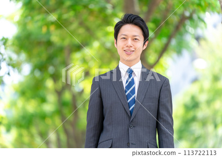 Businessman walking through the fresh greenery Businessman walking through the fresh greenery 113722113