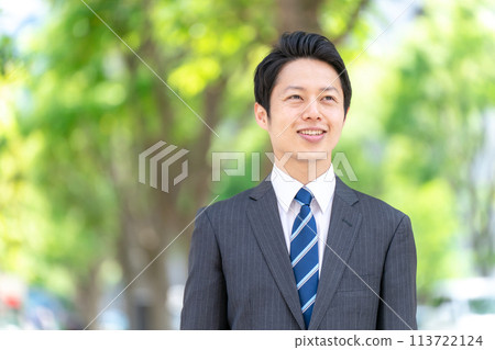 Businessman walking through the fresh greenery Businessman walking through the fresh greenery 113722124