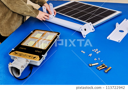 Assembly table for assembling LED street lighting with solar panel, owner prepares mounting bracket. Assembly table for assembling LED street lighting with solar panel, owner prepares mounting bracket. 113722942