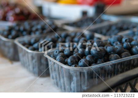Blueberries in trays are sold at the market Blueberries in trays are sold at the market 113723222
