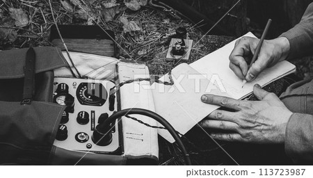 Russian Soviet Infantry Red Army Soldier In World War II using Russian Soviet Portable Radio Transceiver In Trench Entrenchment In Spring Autumn Forest. . Headphones And Telegraph Key. Close Up Hands Russian Soviet Infantry Red Army Soldier In World War II using Russian Soviet Portable Radio Transceiver In Trench Entrenchment In Spring Autumn Forest. . Headphones And Telegraph Key. Close Up Hands 113723987