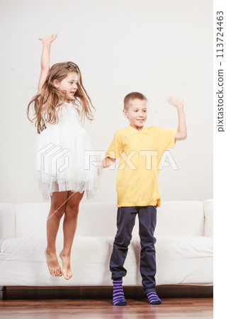Happy cute kids little girl and boy jumping. 113724463