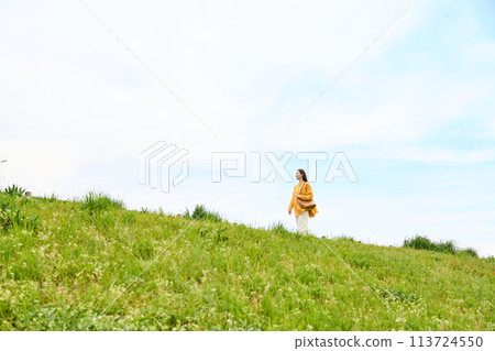 A woman walking the bank A woman walking the bank 113724550