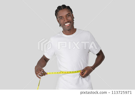 Man using a tape measure on his waist Man using a tape measure on his waist 113725971