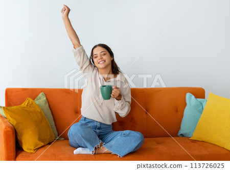 Relaxed Young Woman With Mug Of Tea Relaxing On Couch At Home 113726025
