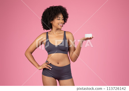 Smiling woman holding product on palm Smiling woman holding product on palm 113726142
