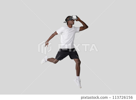 Young man in VR headset with dynamic pose Young man in VR headset with dynamic pose 113726156
