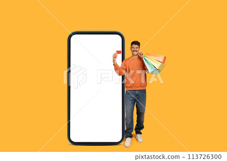 Millennial shopping with colorful bags and phone 113726300