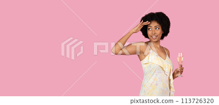 African American woman saluting with champagne glass African American woman saluting with champagne glass 113726320