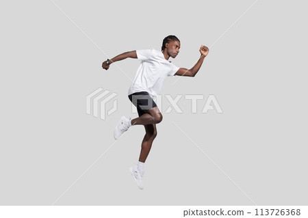 Athlete in motion jumping on a gray background Athlete in motion jumping on a gray background 113726368