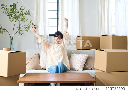 A woman surrounded by moving luggage 113726393
