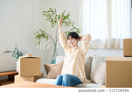 A woman surrounded by moving luggage 113726394