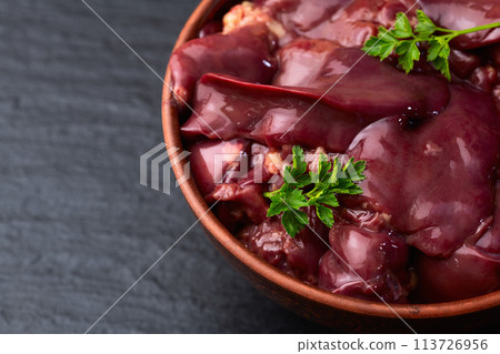 Raw chicken giblets liver, meat background. 113726956