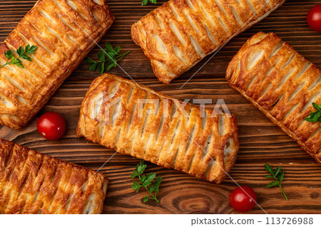 Golden Puff pastry stuffed with sausage and cheese 113726988