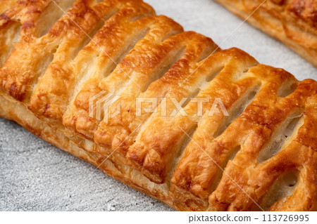 Golden Puff pastry stuffed with sausage and cheese 113726995